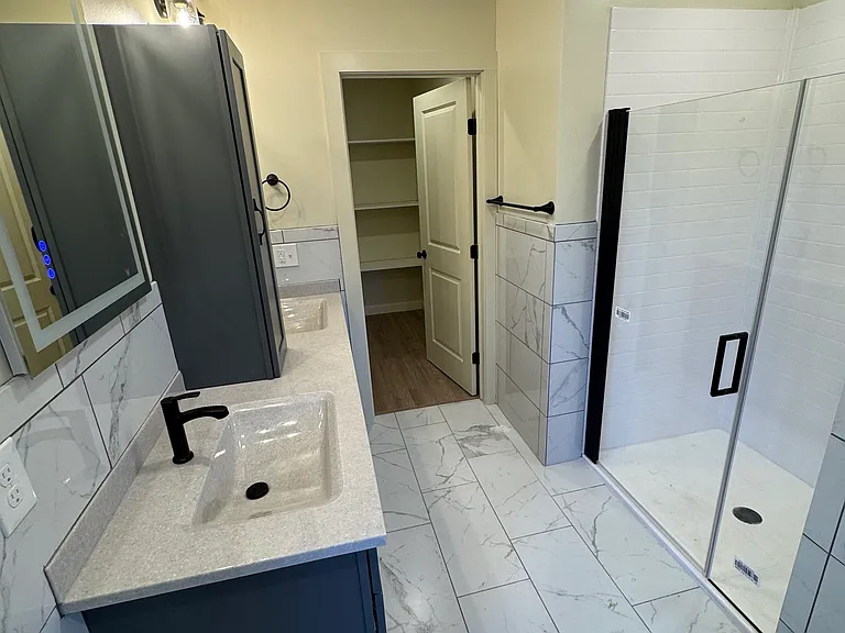 Lighted mirrors, tiled, walk in closet