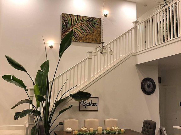 Dinning room with 18 foot vaulted ceilings and 14 foot plant (which will need to stay in the property)