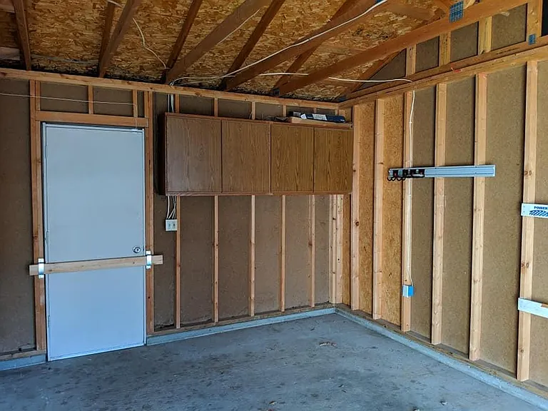 Garage - Cabinets and door to back yard