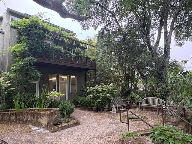 view from common garden area to front door and seating areas