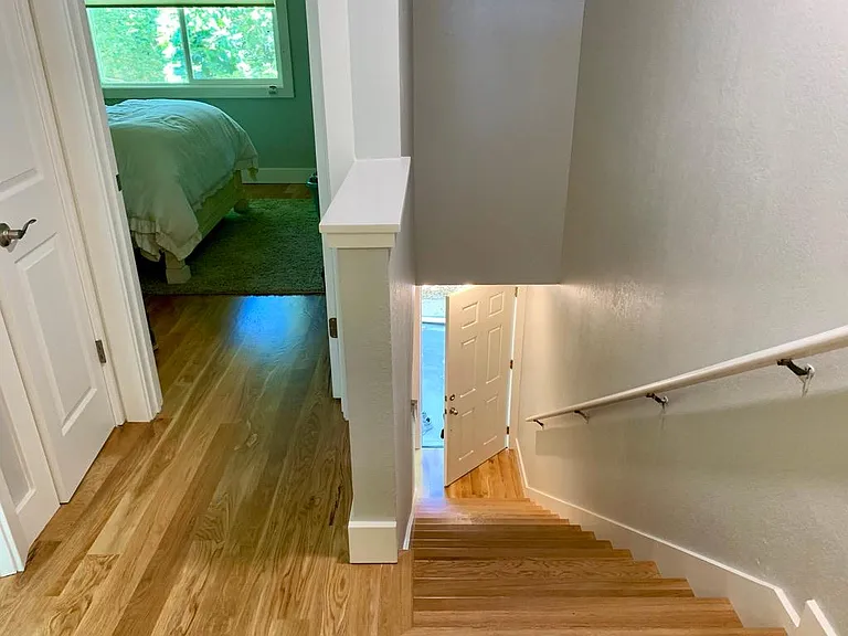 Stair case leading to 2nd floor with a landing area and laundry closet