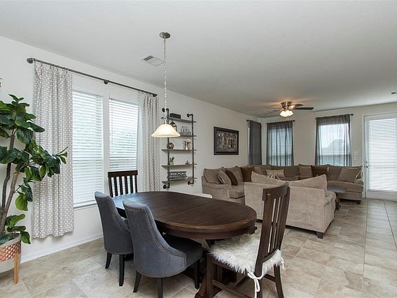 This open floor plan offers nice, cool colored ceramic tile flooring and plenty of windows for natural lighting.