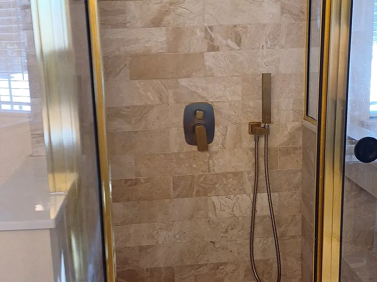marble shower in master bathroom