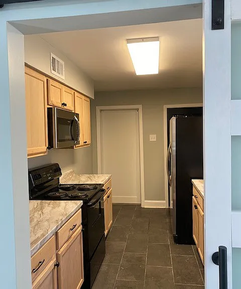 Renovated Kitchen with tile flooring and new cabinets