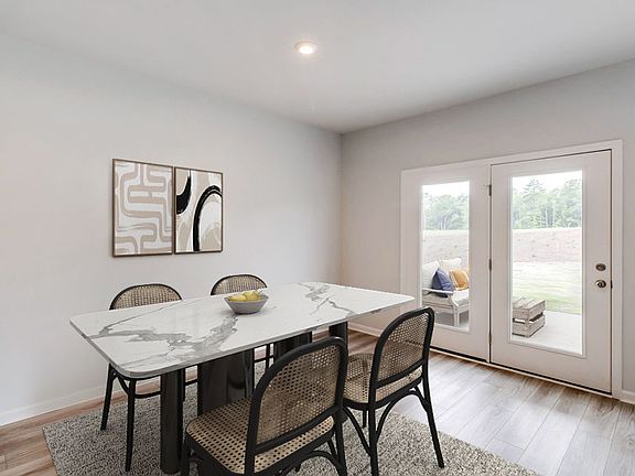 Enjoy meals in the Cafe area that opens to the Kitchen and Gathering Room. - Model Representation