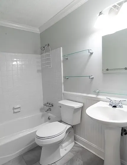 Hallway bath with luxury vinyl plank floor, tub/shower combination and pedestal sink