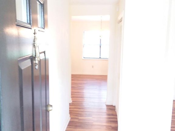 Looking in the front door, living room is to the right and the dining room straight ahead