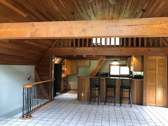 High beam ceiling with large tiled living room.