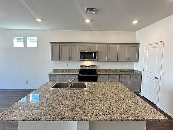 Kitchen with granite countertops and all stainless steel appliances