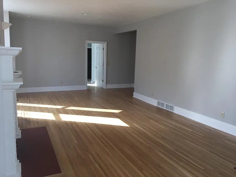 Livingroom with hardwood plank flooring.