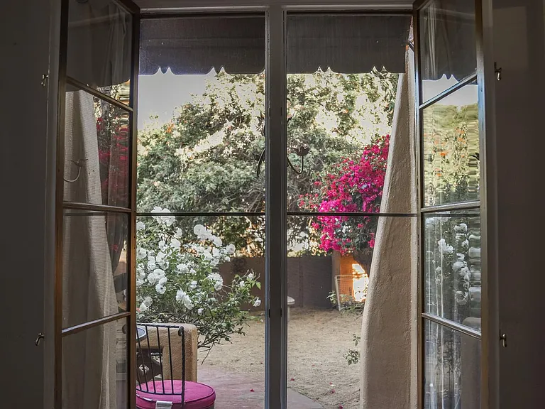French windows in dining room open to the front yard