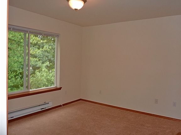 Kitchen with white appliances and tile countertops and a nice sized pantry