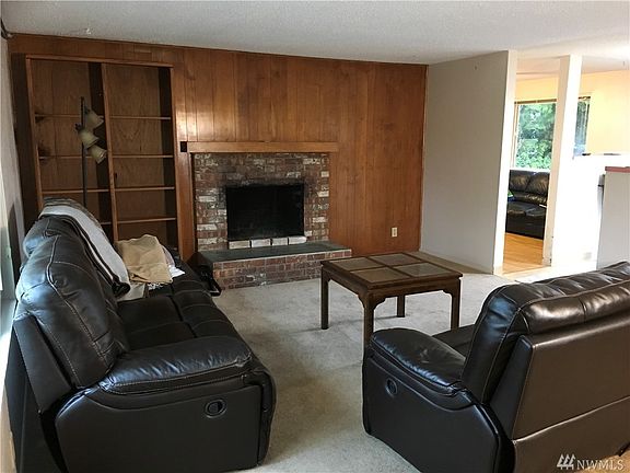 Living room with cozy wood burning fireplace.