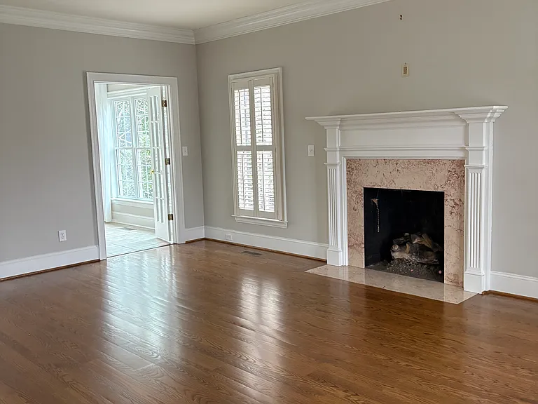 Living Room with fireplace/gas logs attached to the Sunroom and Dining Room