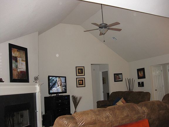 Living room with vaulted ceiling and gas/wood burning fireplace.