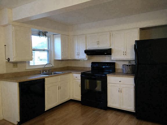 Kitchen has dishwasher, electric range/oven and refridgerato