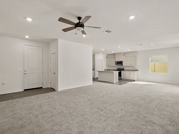 The family room is spacious with a ceiling fan.
