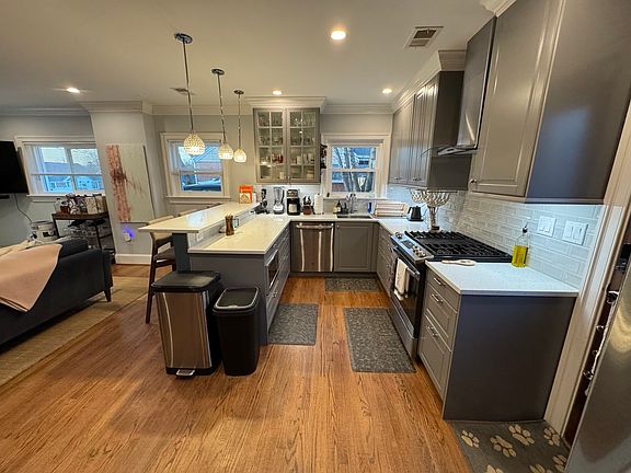 Stainless steel appliances, gas 5-burner stove, large deep cabinets.