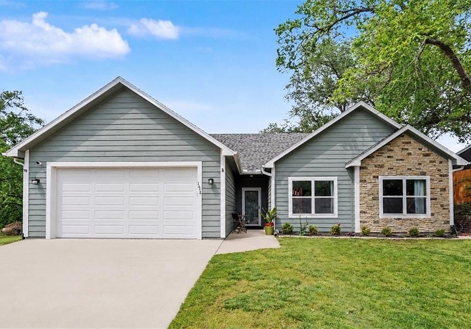 Contemporary exterior featuring horizontal siding and stone veneer accents