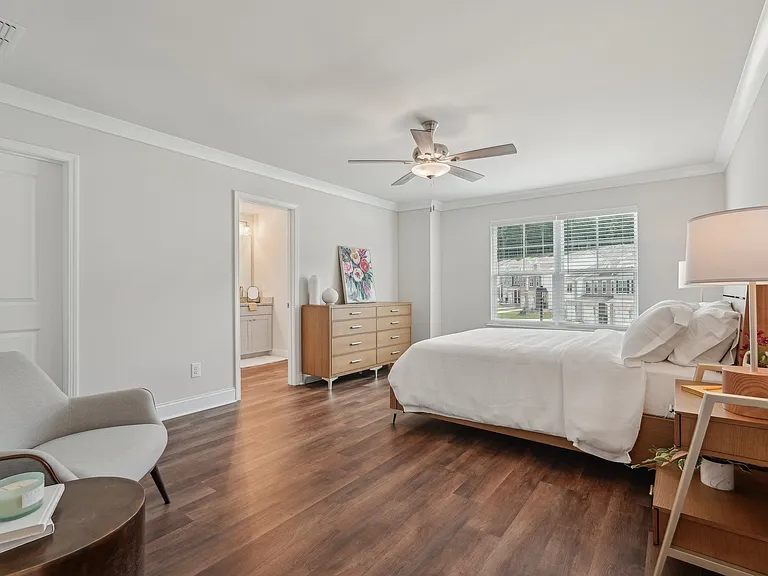 Primary Bedroom with king size bed and large window letting in nice natural light.