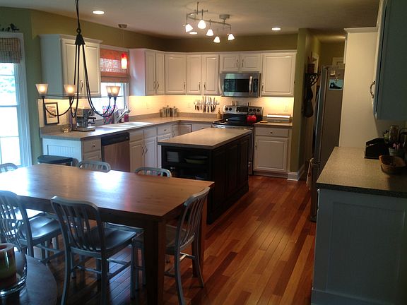 all stainless appliances, under-cabinet lighting, subway tile backsplash