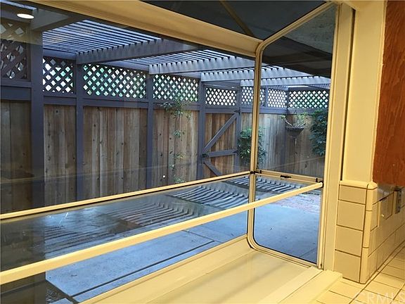 Garden window over sink, looking into private rear patio.