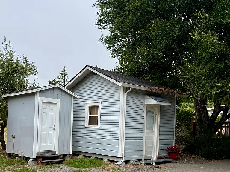Detached office on right, with view to orchard and outside visitors bathroom