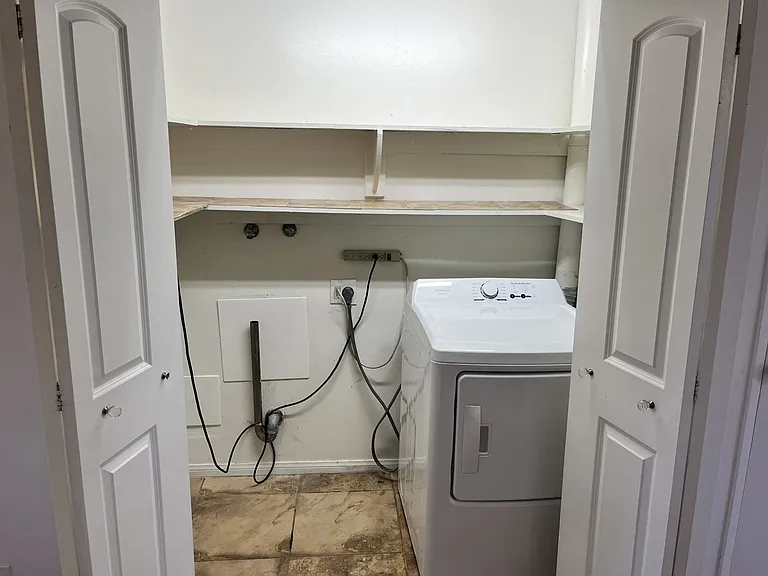 laundry closet with extra storage and lighting