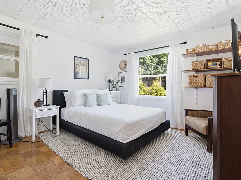 Secondary bedroom with brand new queen Helix mattress and vanity with sink