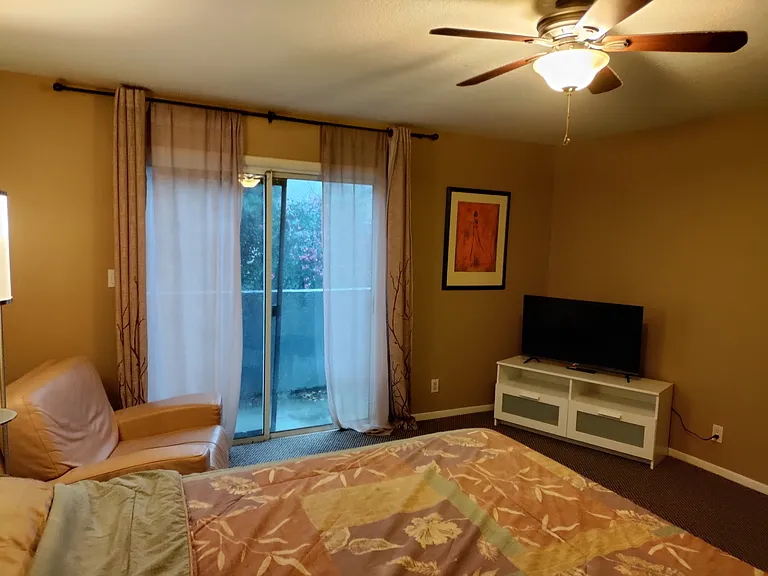 Upstairs back bedroom with private balcony.