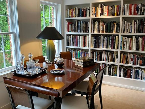 Dining and library, table expands for larger seating. Hardwood floors throughout the house.