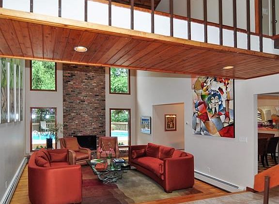 Step down living room with brick fireplace. Long windows thru-out to add brightness indoors