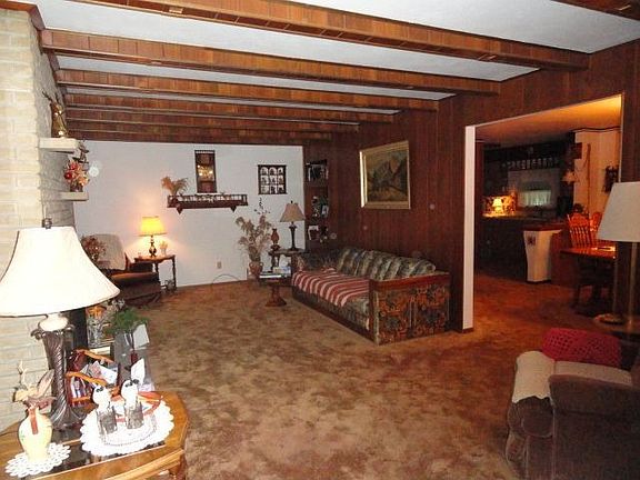 Spacious living room with custom lighting in ceiling beams