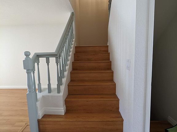 Staircase to top level and down to garage