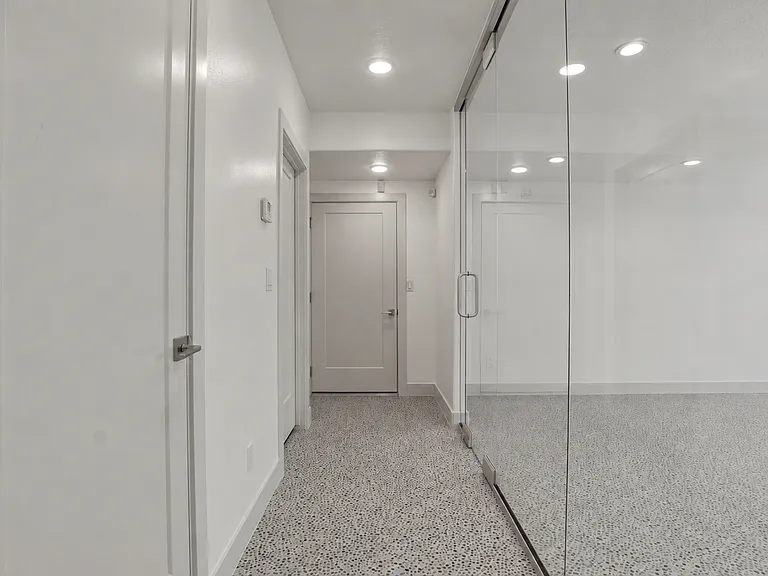 Hallway to storage room, storage closet on left also