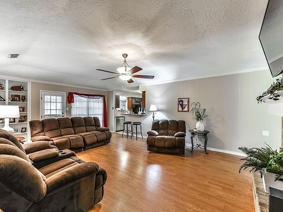 This large family room has wood flooring.