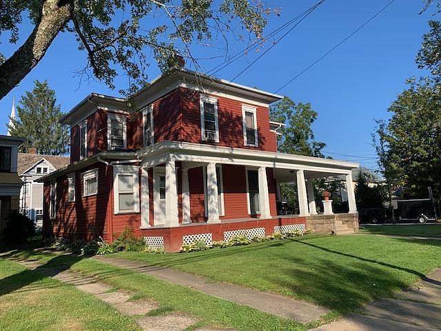 Large front wrap-around porch; corner lot with yard.