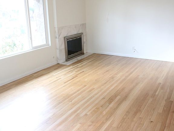Living room with picture window to front and fireplace.