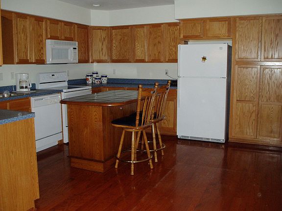 Spacious Kitchen with Hardwood flooring, Island with seating and more