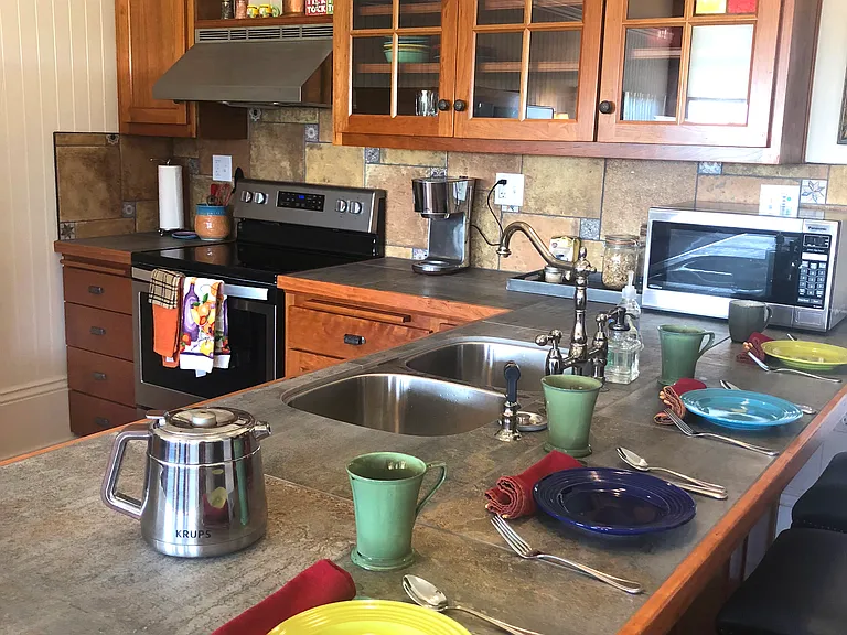 Hang out with your guests at the breakfast bar with service for four in our fabulous upscale kitchen.