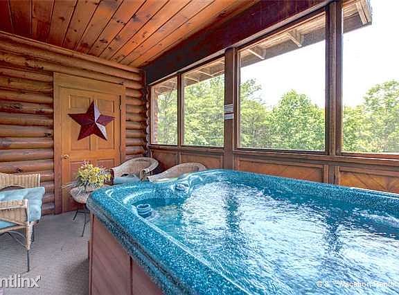 A private hot tub in the screened-in porch