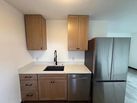 Kitchen with disposal and fridge with ice maker.