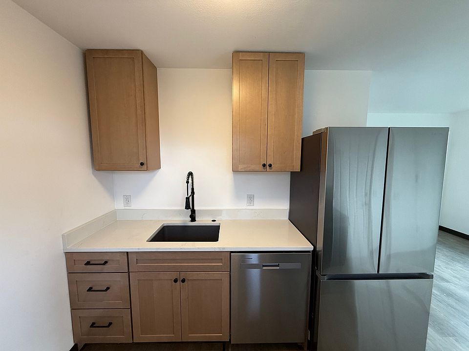 Kitchen with disposal and fridge with ice maker.
