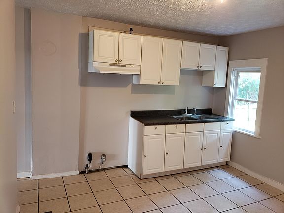 Kitchen with updated cabinets, countertop, sink and faucet