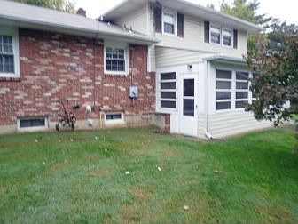 Enclosed rear porch off lower level family room