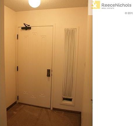 Hallway as you step inside the unit.  Coat closet is located to