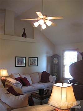 The beautiful formal living room with vaulted ceiling and open decorative areas.