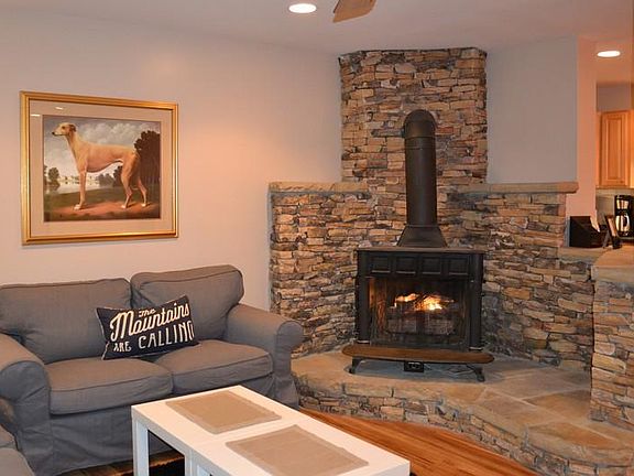 Living room with handstacked stone fireplace hearth and free
