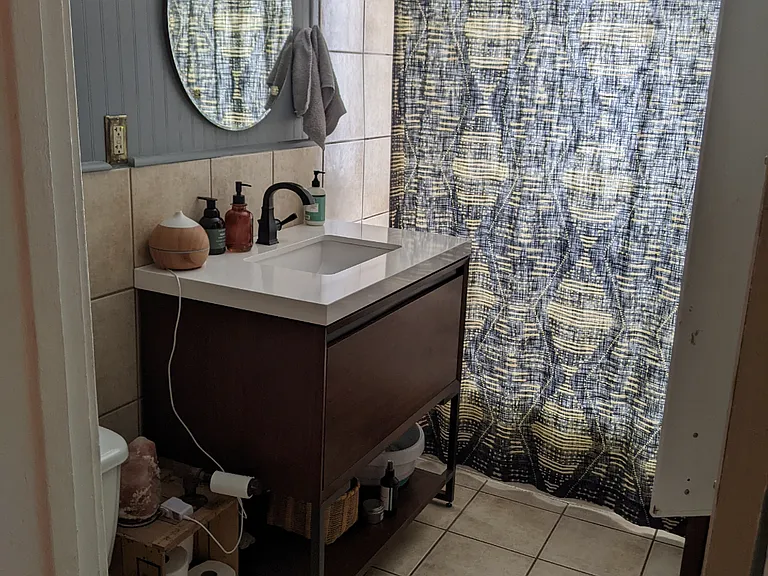 Bathroom has a large storage area behind the door (not pictured)