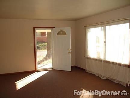 Living room with view of side door and picture window